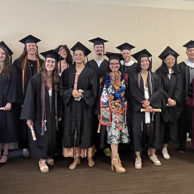 Group Photo at Linguistics 2025 Graduation. A line of graduates and faculty in regalia